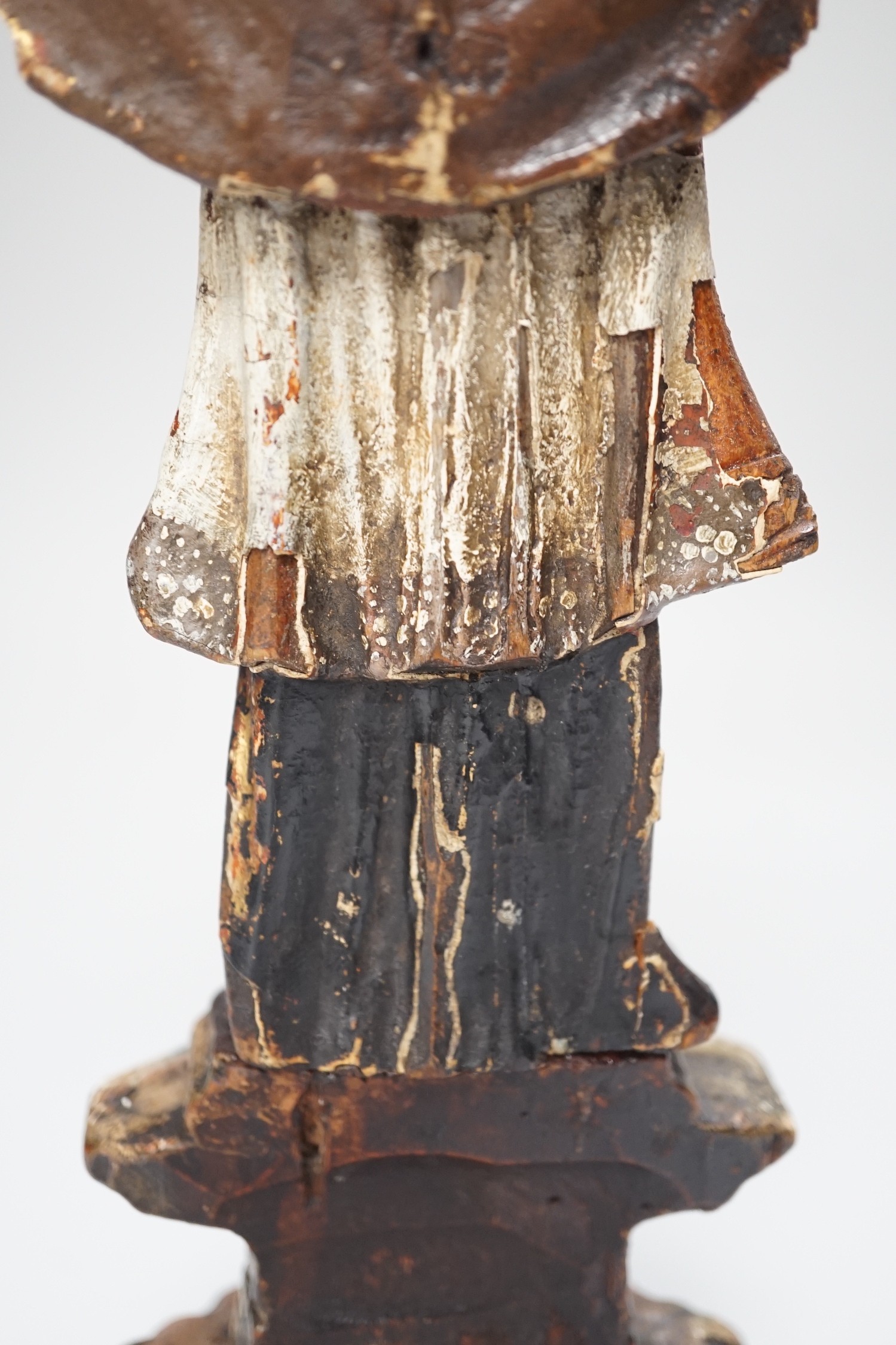 An 18th/19th century Continental carved wooden polychrome figure of saint, 33cms high